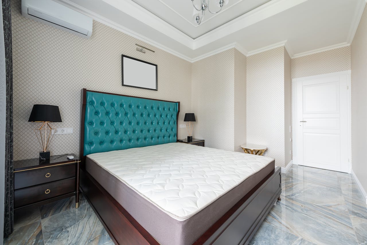 why-choose-us Stylishly designed modern bedroom with luxurious teal headboard and marble floor.